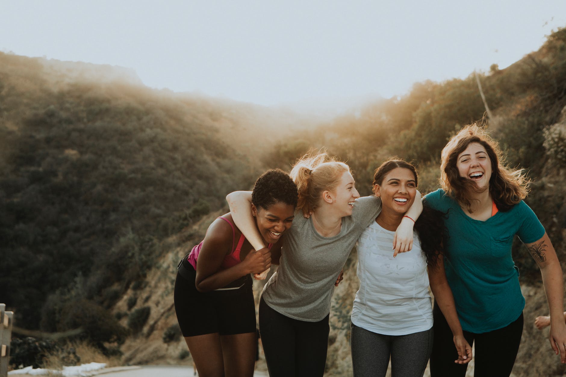 four women standing on mountain